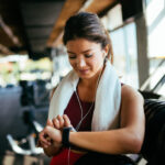 Woman checking workout watch at the gym