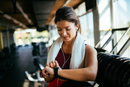 Woman checking workout watch at the gym