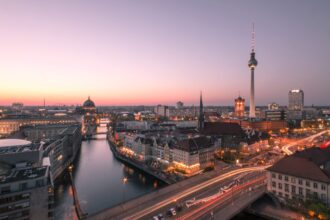 Illuminated Buildings In Berlin Against Sky During Sunset