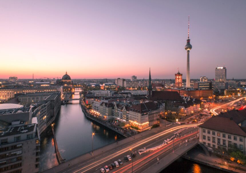 Illuminated Buildings In Berlin Against Sky During Sunset