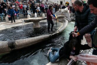 Climate activists dye Spanish Steps fountain water black