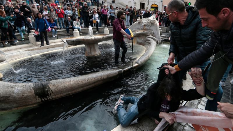 Climate activists dye Spanish Steps fountain water black