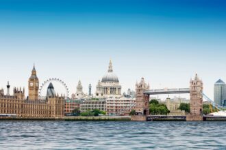 London montage against plain blue sky with River Thames in foreground