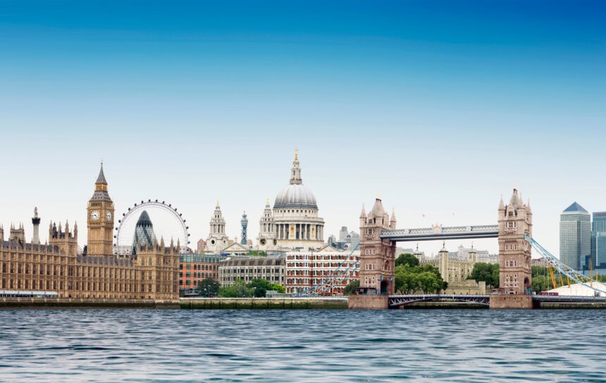 London montage against plain blue sky with River Thames in foreground