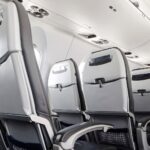 Empty airplane seats in second class on an international flight during August peak season