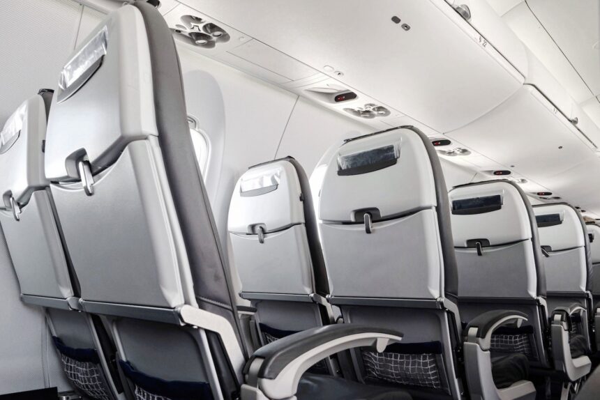 Empty airplane seats in second class on an international flight during August peak season