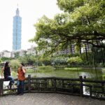 Chinese man and woman talking in a park