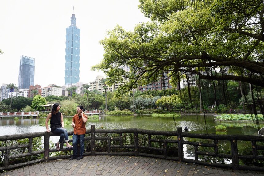 Chinese man and woman talking in a park