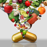 Gold pill capsule bursting open with a variety of fruits and vegetables shooting out of it and up out of the photo.