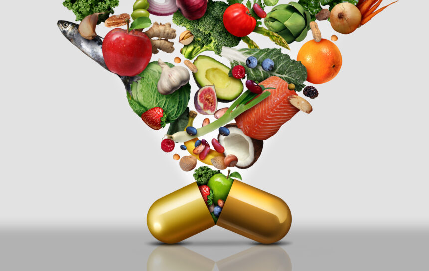 Gold pill capsule bursting open with a variety of fruits and vegetables shooting out of it and up out of the photo.