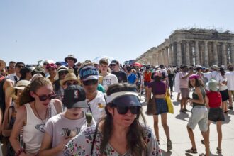 Greek PM warns of hard times as temperatures soar