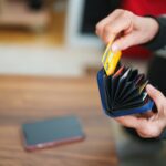 Senior woman taking out her credit card from wallet