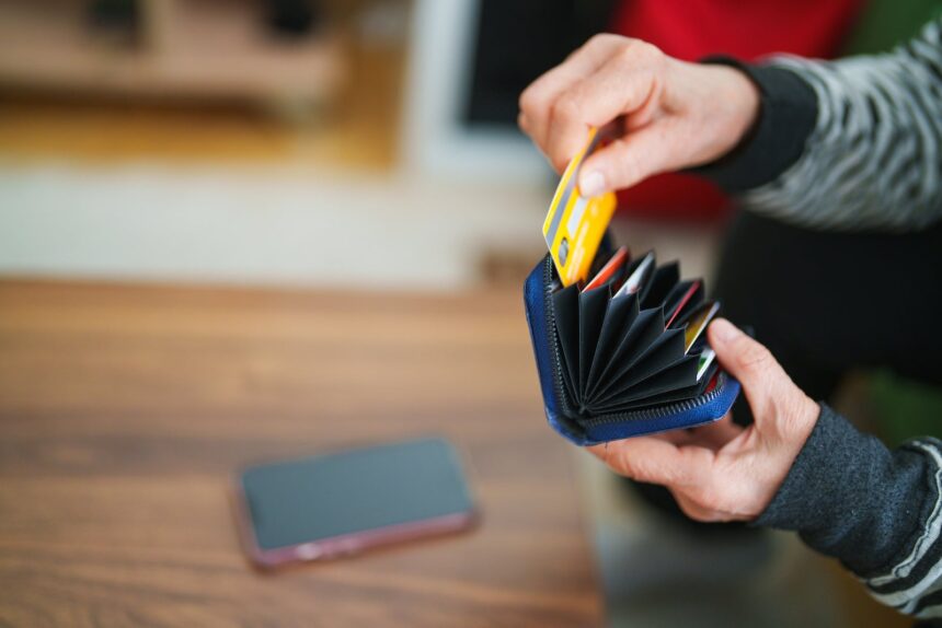 Senior woman taking out her credit card from wallet