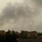 Smoke billows over buildings in southern Khartoum on 29 May 2023, amid ongoing fighting between the forces of two rival generals.