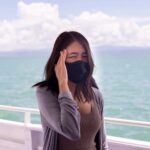 Woman suffering from sea sickness and feeling headache while on boat