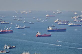 Ships wait at Asian ports as retailers struggle to shift excess stock