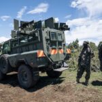 Ugandan soldiers from the East African Community Regional Force (EACRF) stand guard near one of their bases in Bunagana, on 19 April 2023.