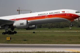 A TAAG Angola Airlines Boeing 777-300ER plane takes off from Lisbon airport in Portugal.