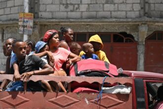 Locals evacuate the Carrefour Feuilles commune in Port-au-Prince, Haiti, as gang violence continues, 15 August 2023.