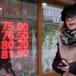 Russian ruble weakens past symbolic threshold of 100 against the dollar