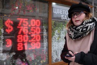 Russian ruble weakens past symbolic threshold of 100 against the dollar