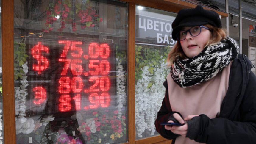 Russian ruble weakens past symbolic threshold of 100 against the dollar