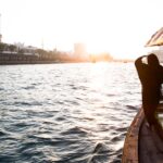 arab woman crossing Dubai Creek on a boat