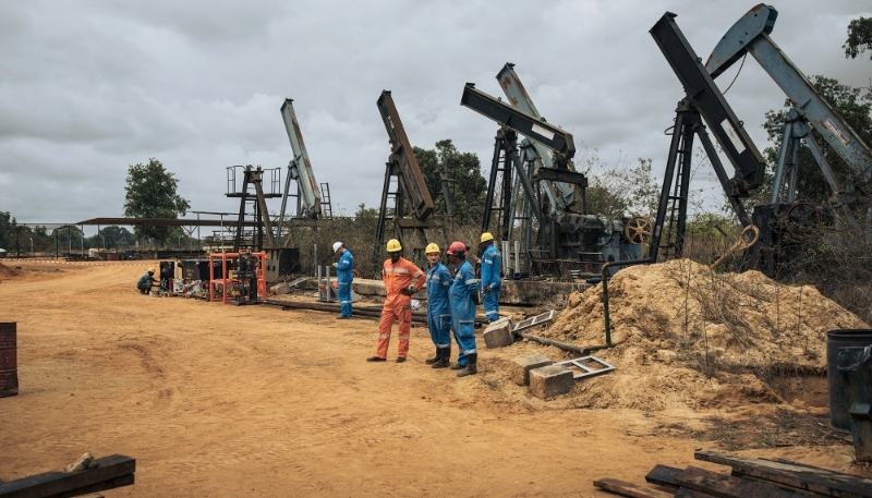 Perenco oil company managers and technicians near the onshore oil wells in operation on the outskirts of Muanda, on the southwestern tip of the DRC on 19 October 2021.