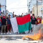 Opposition demonstrators hold a flag during a demonstration in Andravoahangy, Antananarivo, on 11 November 2023.