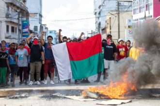 Opposition demonstrators hold a flag during a demonstration in Andravoahangy, Antananarivo, on 11 November 2023.