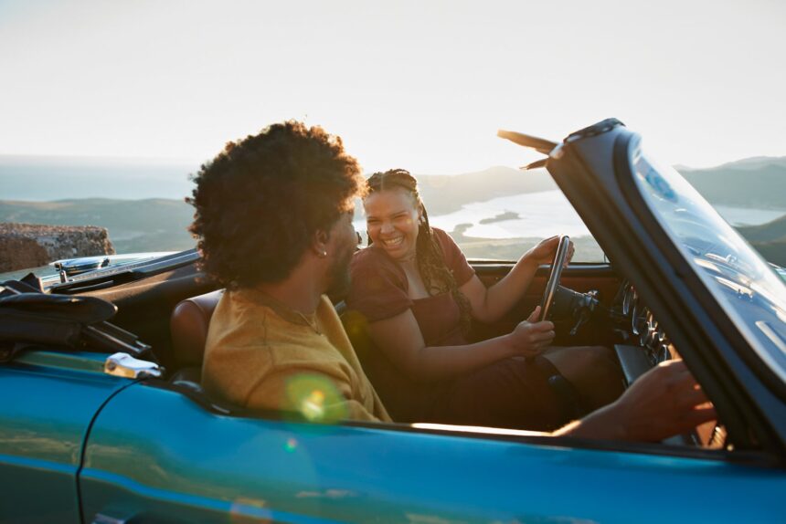 Woman driving by boyfriend sitting in car