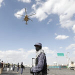 A helicopter flies over a crowd.