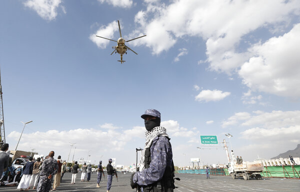 A helicopter flies over a crowd.