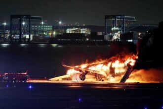 Japan Airlines plane in flames on runway at Tokyo airport