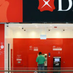 DBS cuts executive pay on banking outages; posts record earnings in 2023