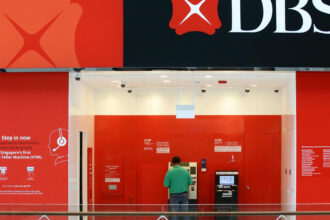 DBS cuts executive pay on banking outages; posts record earnings in 2023