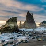 Man on Rialto Beach, Forks, Washington, USA.