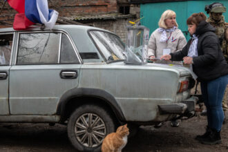 In Occupied Ukraine, Casting a Vote (for Putin) as Armed Soldiers Watch